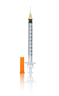 Plastic syringe vertical with white background